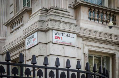 Whitehall and Downing Street signs on the corner of the Department For Exiting the EU building.